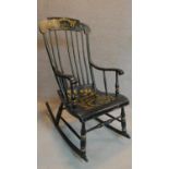 A 19th century ebonised and gilt painted rocking chair. H.113cm