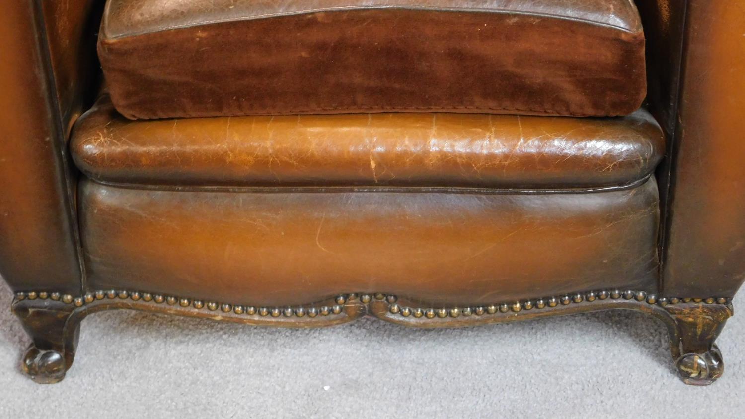 A pair of vintage beech framed leather club armchairs on cabriole feet to front and back. H.80 W. - Image 2 of 3