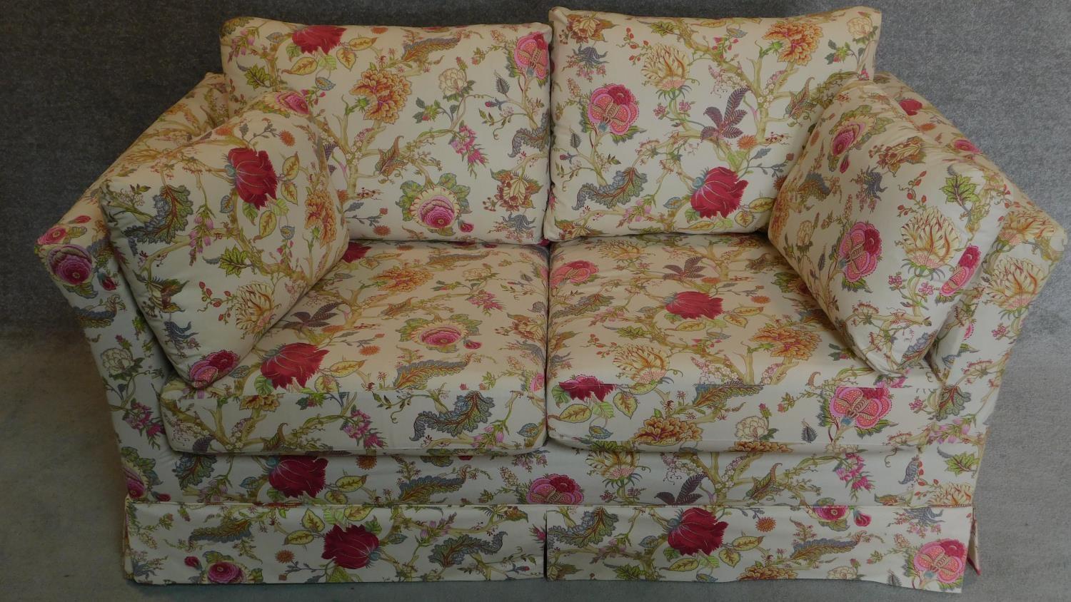 A floral upholstered two seater sofa. 74x160x88cm