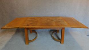 An Arts and Crafts oak draw leaf dining table. 74x255x100cm