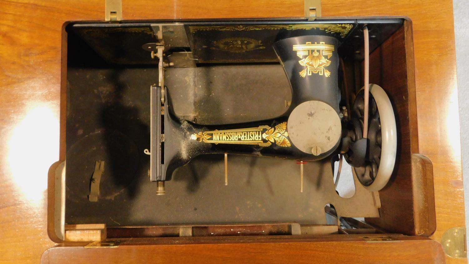 A vintage Frister and Rossman sewing machine in a fitted walnut side table. 80x70x50cm - Image 5 of 9