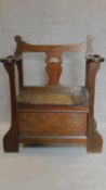 An oak hall settle/umbrella stand with lift up seat. H.86cm