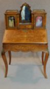 A 19th century Victorian burr walnut bureau de dame fitted cupboards and interior with Arabesque