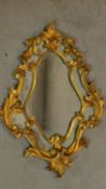 A carved giltwood Florentine style wall mirror. H.71 W.51cm