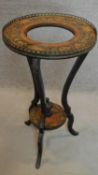 A 19th century ebonised and marquetry inlaid circular stand on triple cabriole supports. H.79cm