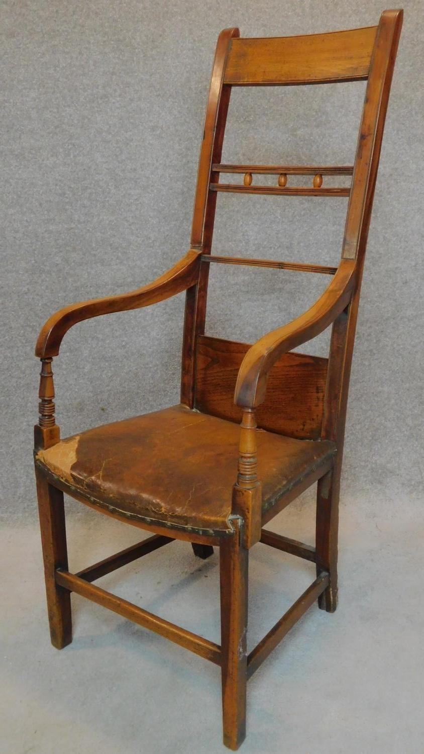 A 19th century country elm and yew armchair. H.124cm