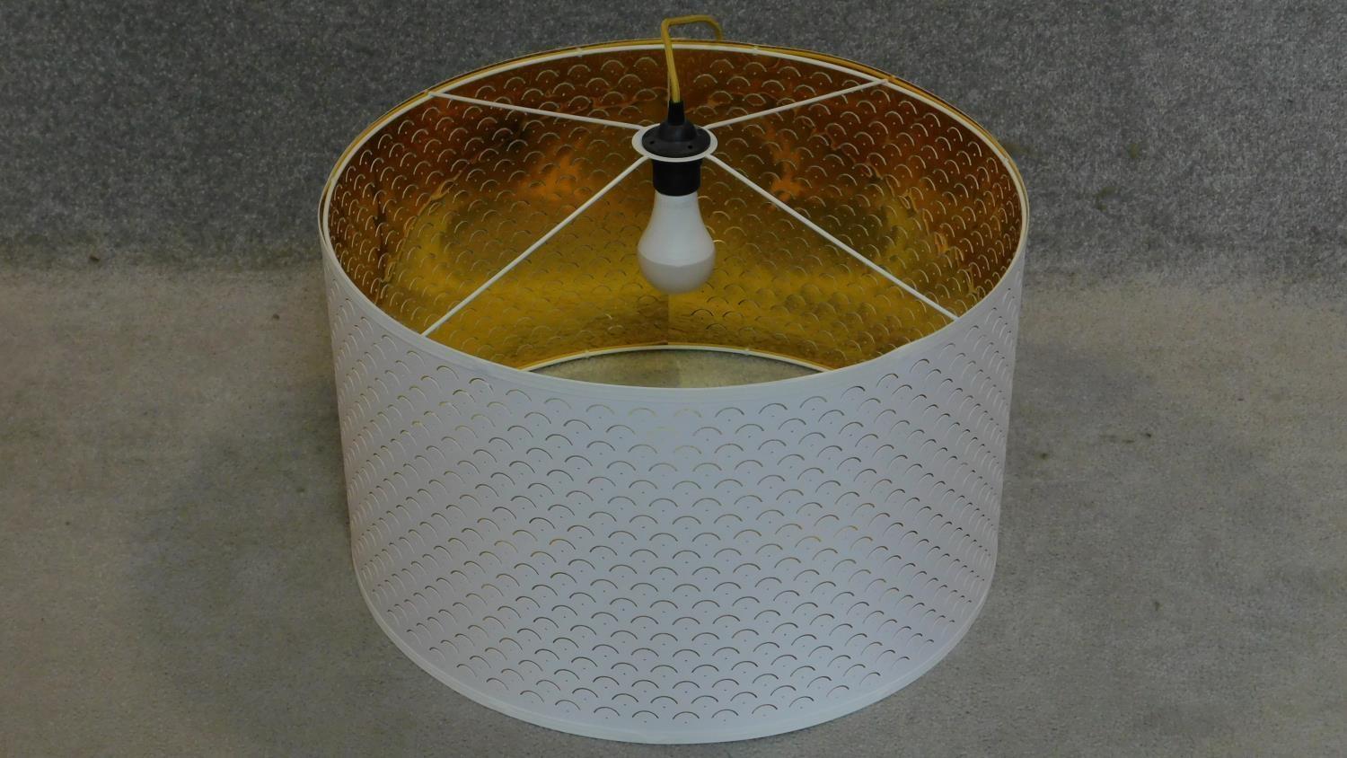 A white cylindrical pendant lamp shade and fitting. 35x60x60cm