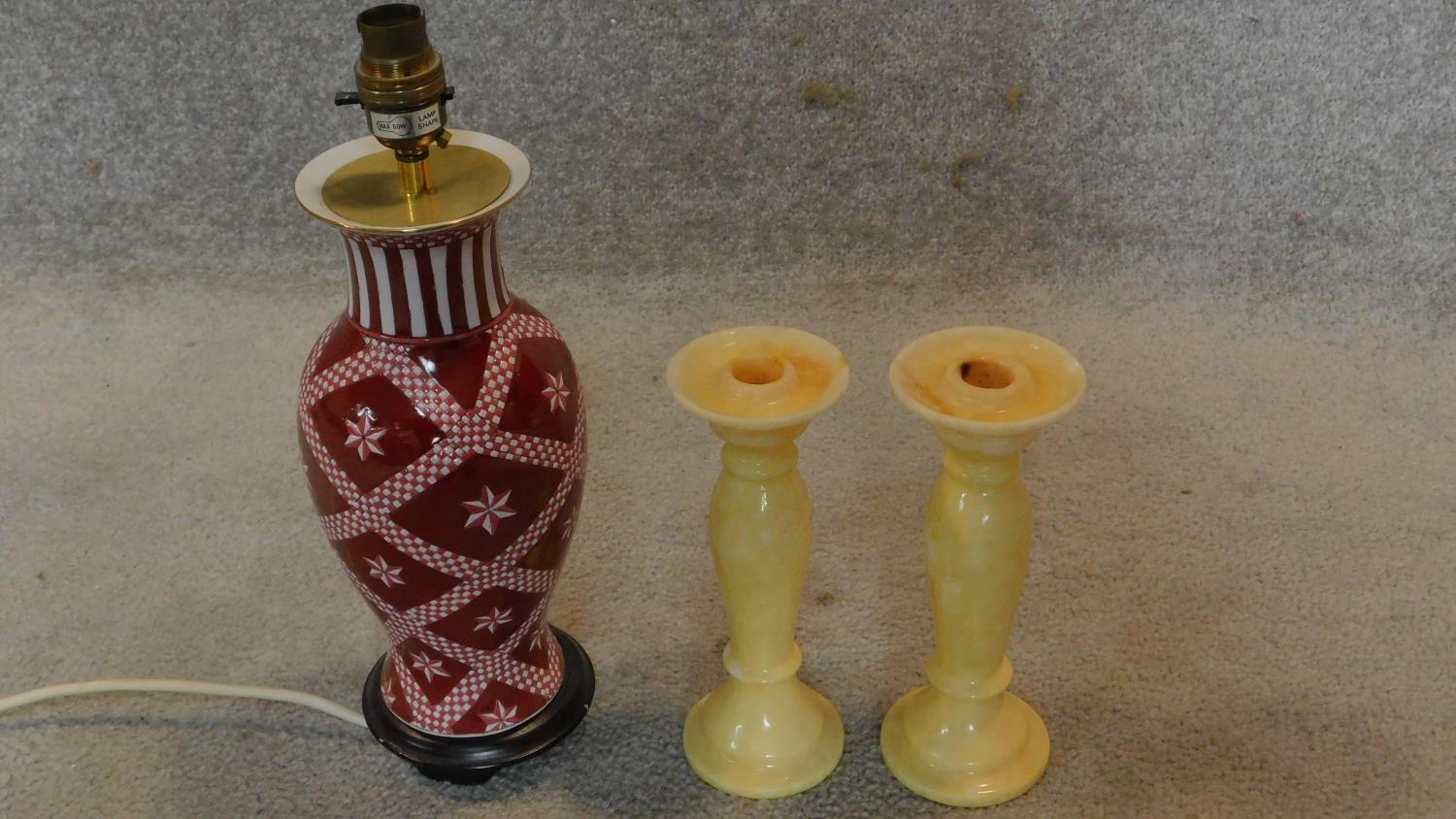A baluster form table lamp and a pair of onyx candlesticks. H.35cm