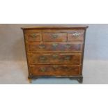 A mid Georgian walnut and featherbanded chest of three short over three long drawers.