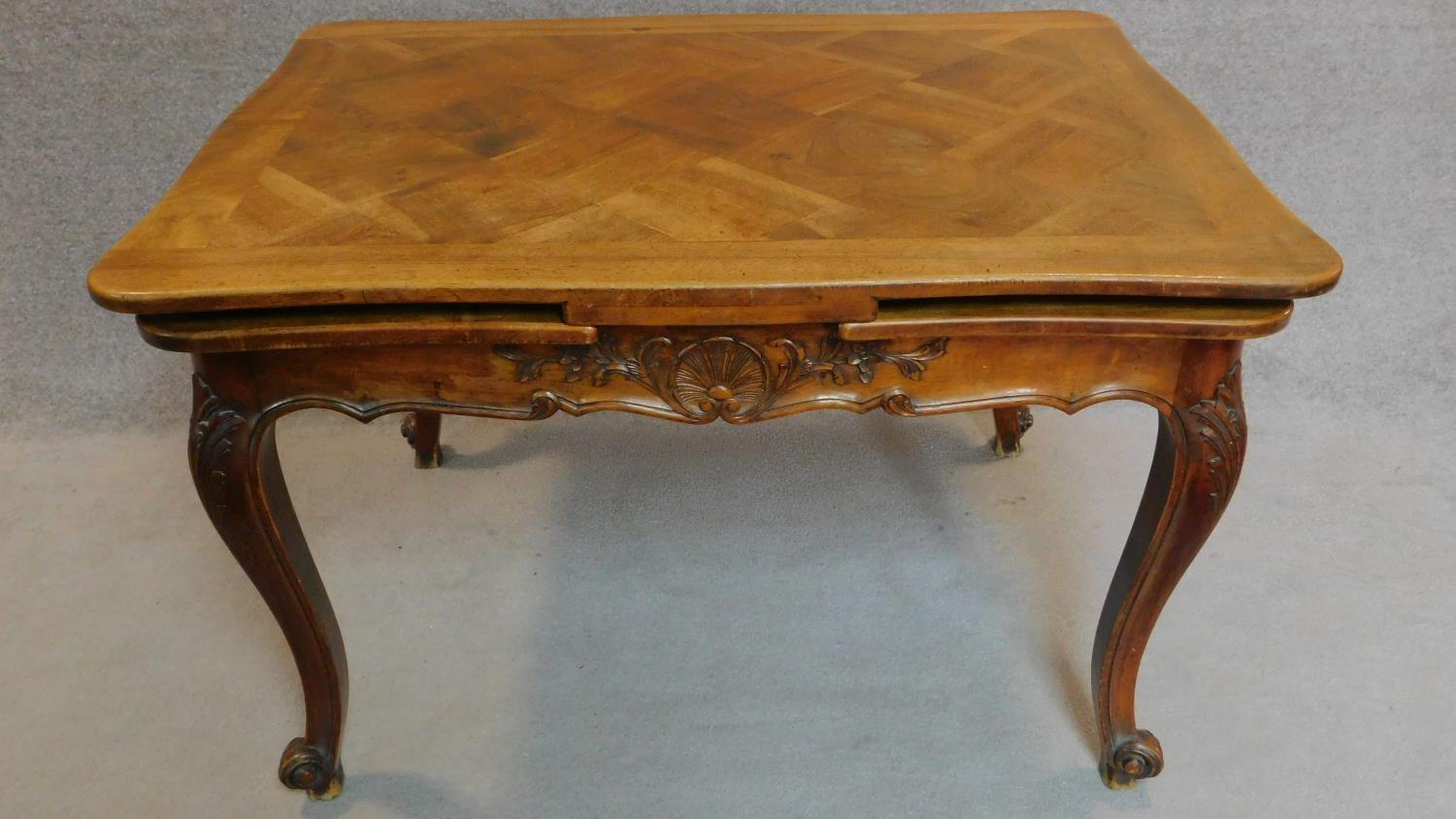 A French walnut draw leaf dining table with parquetry top on well carved base with cabriole - Image 5 of 5