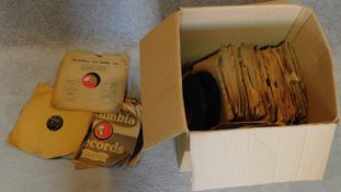 A large collection of over 100 old 78 rpm records.