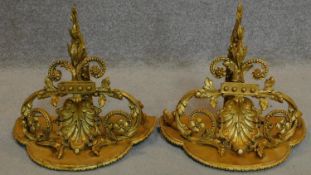 A pair of 19th century decorative gilt wall brackets with rococo shell and floral swag decoration.