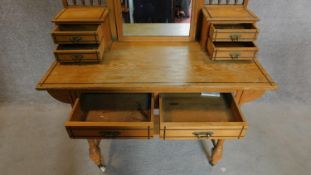 A Victorian Ash aesthetic style dressing table on turned stretchered supports united by undertier.