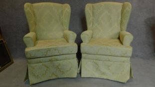 A pair of wing armchairs in floral lemon upholstery. H.107cm