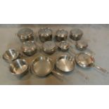 A large collection of stainless steel pots and saucepans.