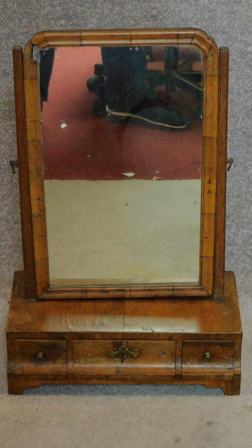 An early Georgian walnut swing mirror fitted drawers to base with original plate. H.56cm