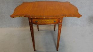 A Sheraton style pembroke table with butterfly drop flaps, crossbanded and with allover