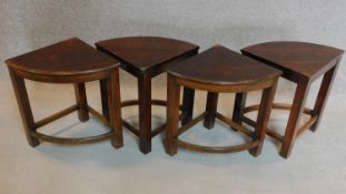 A set of four corner tables to form a circular low table, makers label to underside. H.49cm