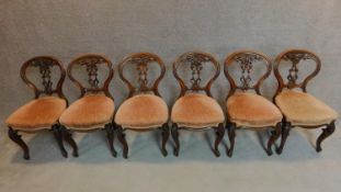 A set of six Victorian carved mahogany balloon backed dining chairs on cabriole supports. H.83cm