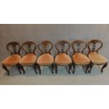 A set of six Victorian carved mahogany balloon backed dining chairs on cabriole supports. H.83cm