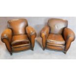A pair of vintage beech framed leather club armchairs on cabriole feet to front and back. H.80 W.