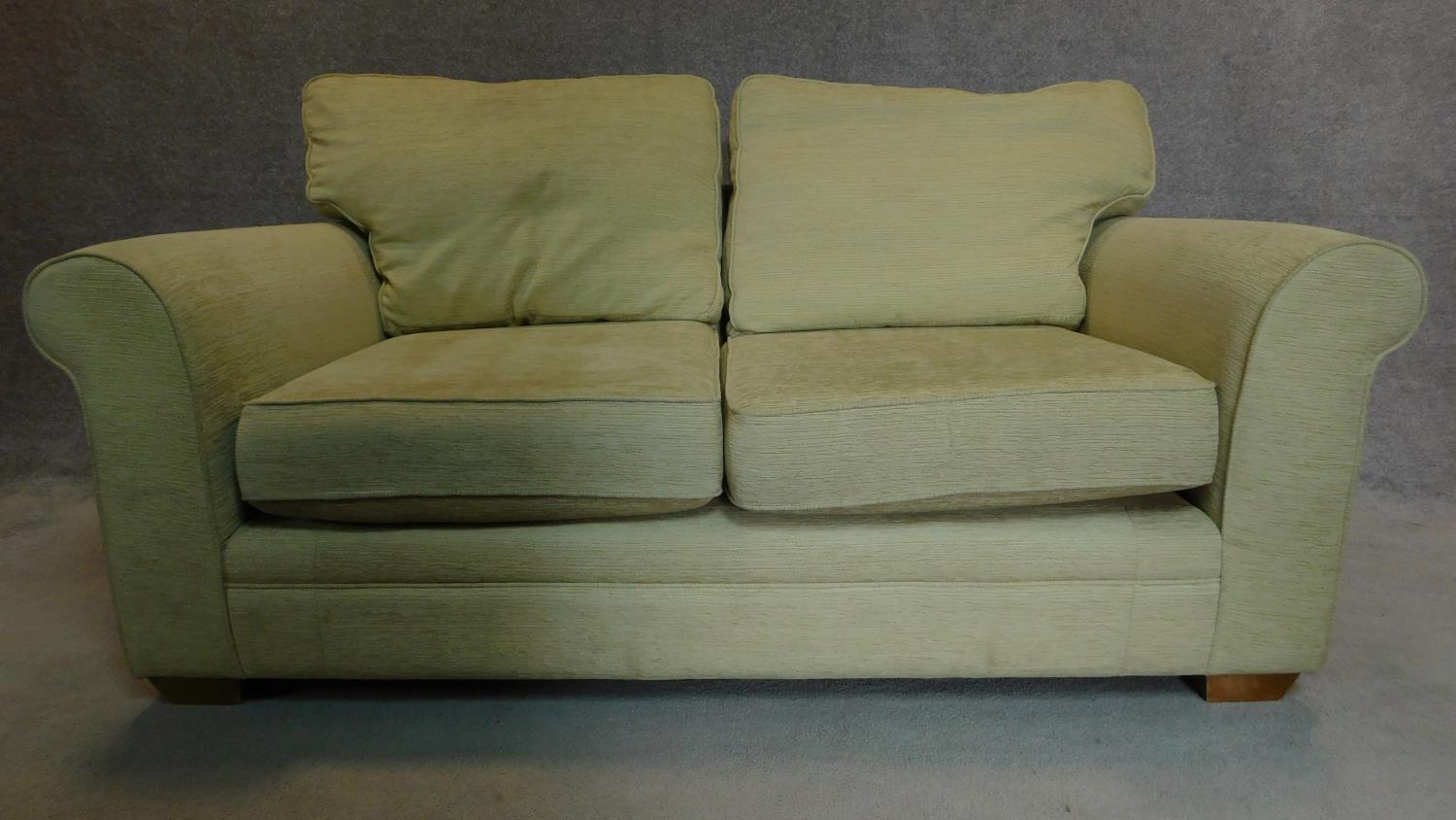 A two seater sofa in cream upholstery. 70x175x90cm - Image 2 of 4