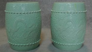 A pair of Chinese barrel shaped garden stools with allover dragon decoration. H.40 W.30cm
