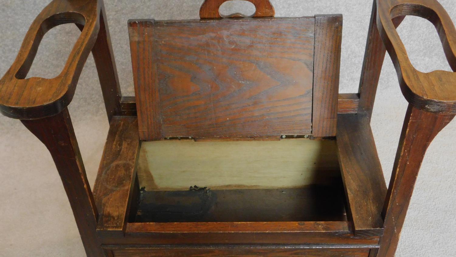 An oak hall settle/umbrella stand with lift up seat. H.86cm - Image 3 of 4