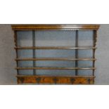 A 19th century poker work wall hanging plate rack fitted with coat hooks to bottom rail. 97x134cm