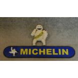 a metal Michelin man figure and a Michelin name plate. 50x9cm