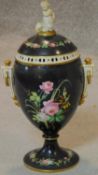 A 19th century Continental hand painted urn and cover. H.40cm
