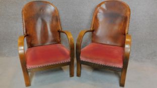 A pair of mid 20th century leather backed armchairs. H.92cm