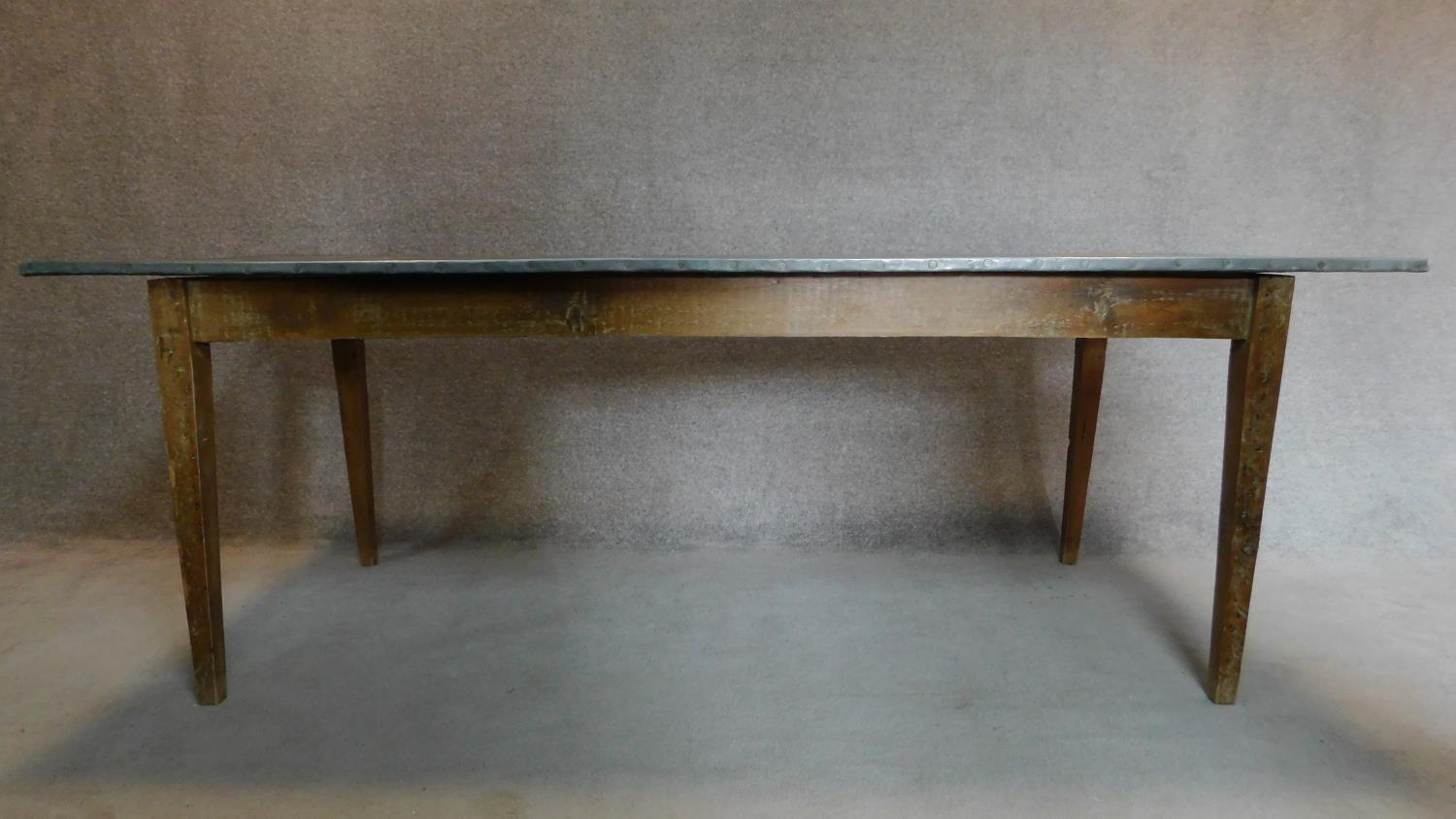 A 19th century pitch pine refectory dining table with studded zinc top on square tapering - Image 2 of 4