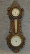 A late 19th century carved oak barometer. W.66cm