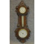 A late 19th century carved oak barometer. W.66cm