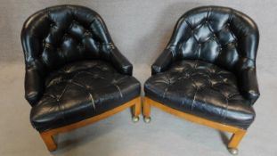 A pair of faux leather buttoned back tub chairs. H.72cm