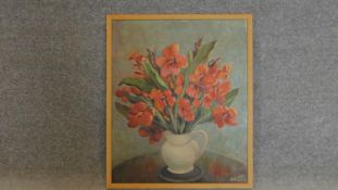 A framed oil on board, flowers in a vase, signed bottom right. 64x54cm