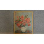 A framed oil on board, flowers in a vase, signed bottom right. 64x54cm