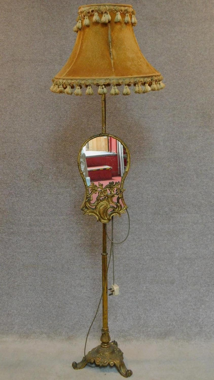 A gilt metal Rococo style standard lamp fitted adjustable glass panel. H.170cm