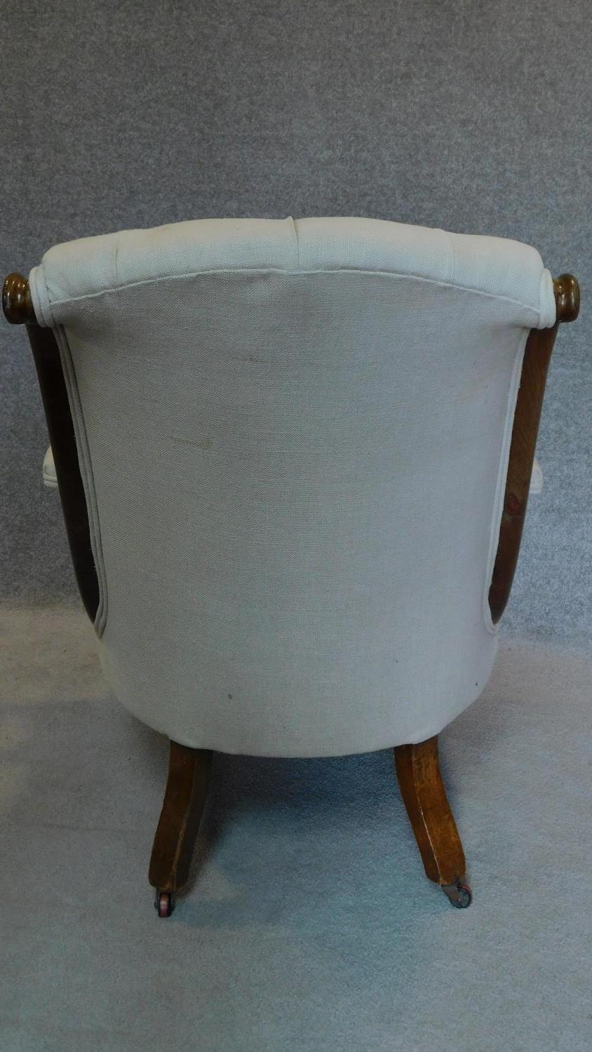 A Victorian mahogany framed buttoned back upholstered easy chair on turned tapering supports. H.91cm - Image 5 of 5