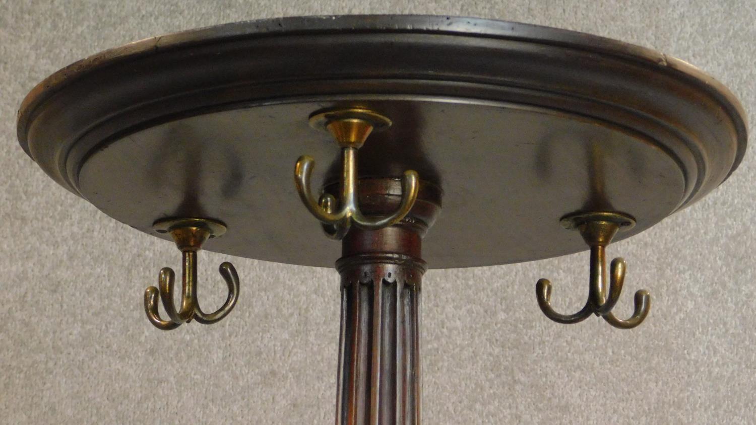 A mahogany coatstand with triple brass hooks on reeded column on quadruped carved cabriole - Image 3 of 5