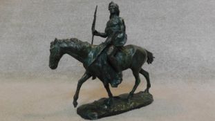 A bronze figure of a native American warrior on horseback. 39x27cm (damage to spear)