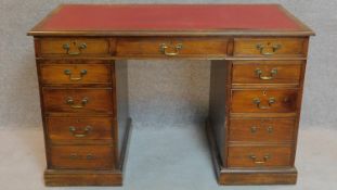 A late Victorian mahogany three section pedestal desk fitted nine drawers with makers label.