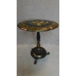A papier mach tilt top table with painted floral decoration and mother of pearl inlay on baluster