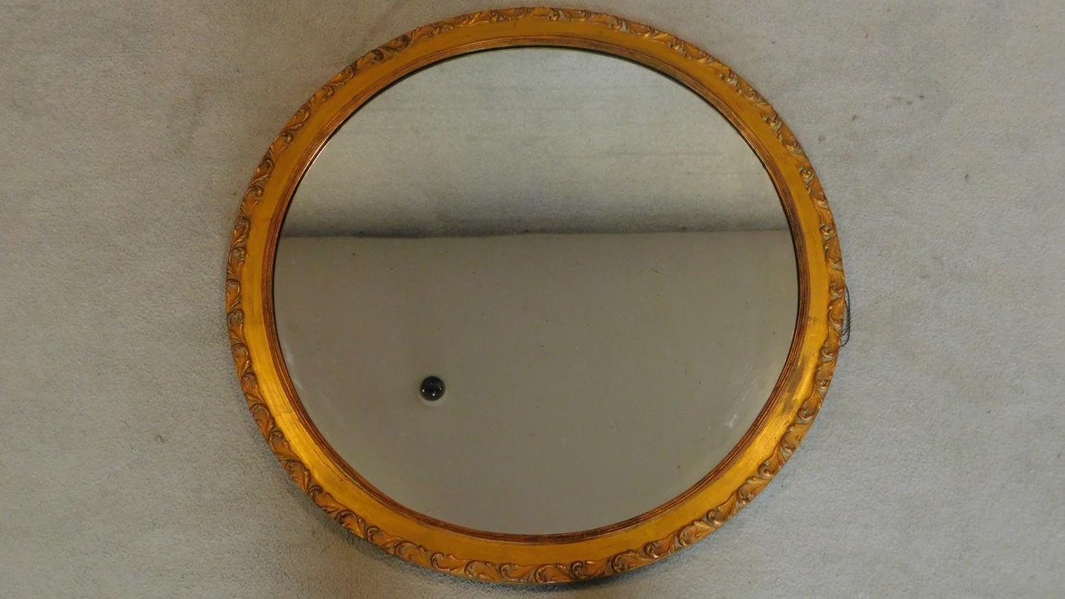 A large 19th century gilt and gesso circular wall mirror. D.86cm