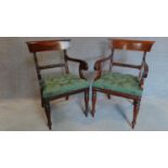A pair of William IV style mahogany armchairs in buttoned floral green upholstery on turned tapering