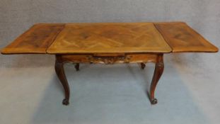 A French walnut draw leaf dining table with parquetry top on well carved base with cabriole