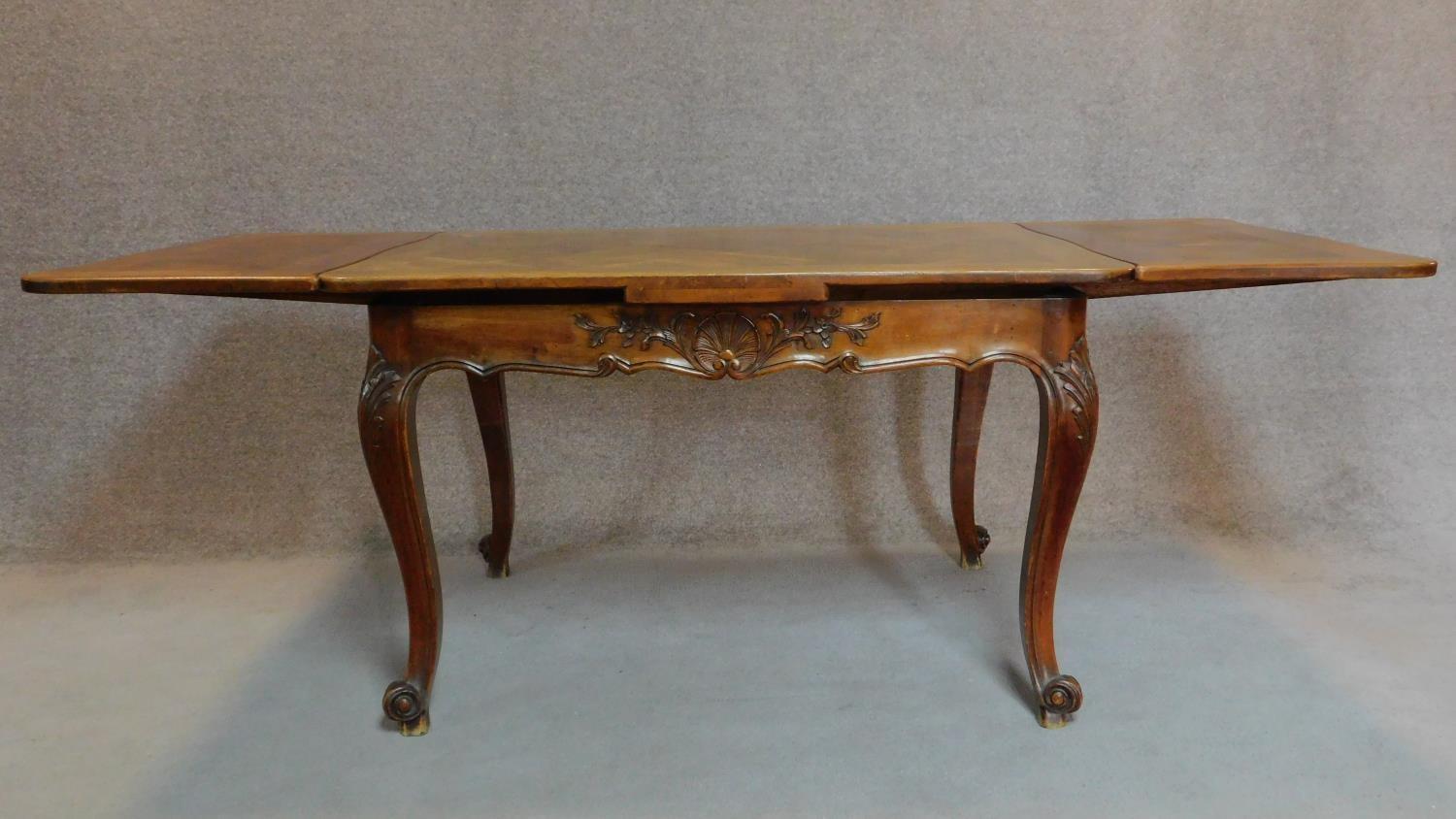 A French walnut draw leaf dining table with parquetry top on well carved base with cabriole - Image 2 of 5