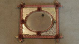 An antique Venetian mirror with oval central plate and etched panels. 51x46cm