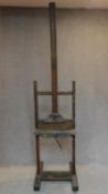 A 19th century oak framed artist's easel with winding adjustable mechanism on block base with